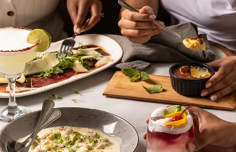 Starters and cocktails shared across a table